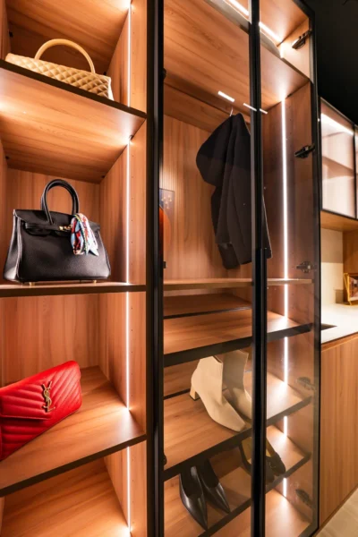 Luxury closet with dark glass doors and integrated LED lighting