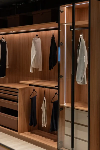 Built-in wardrobe with illuminated shelves and organized clothing compartments