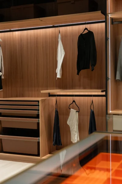 Luxury walk-in closet with illuminated display shelves and designer handbags