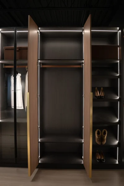 Luxury walk-in closet with illuminated wooden shelves and open wardrobe storage