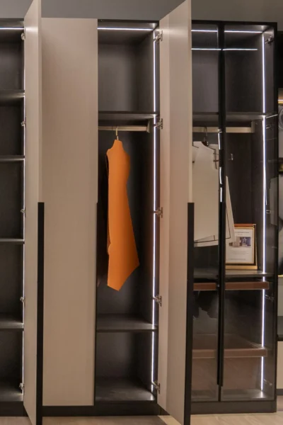 Contemporary walk-in closet with custom shelving and LED illuminated wardrobe compartments