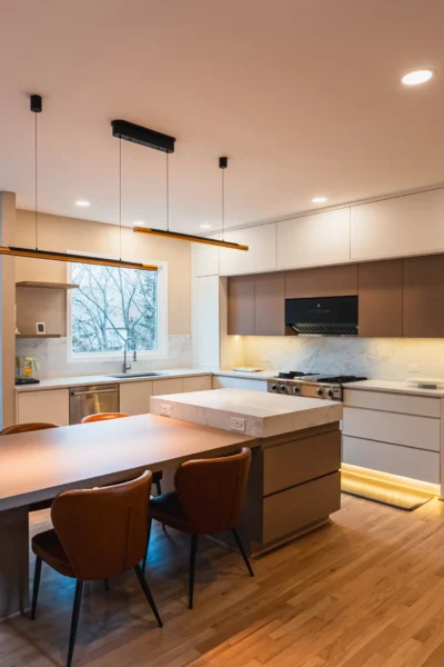 Contemporary kitchen with dining table, large island, and marble backsplash